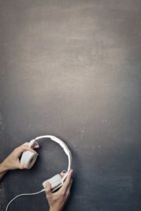 crop man with wired headphones in studio